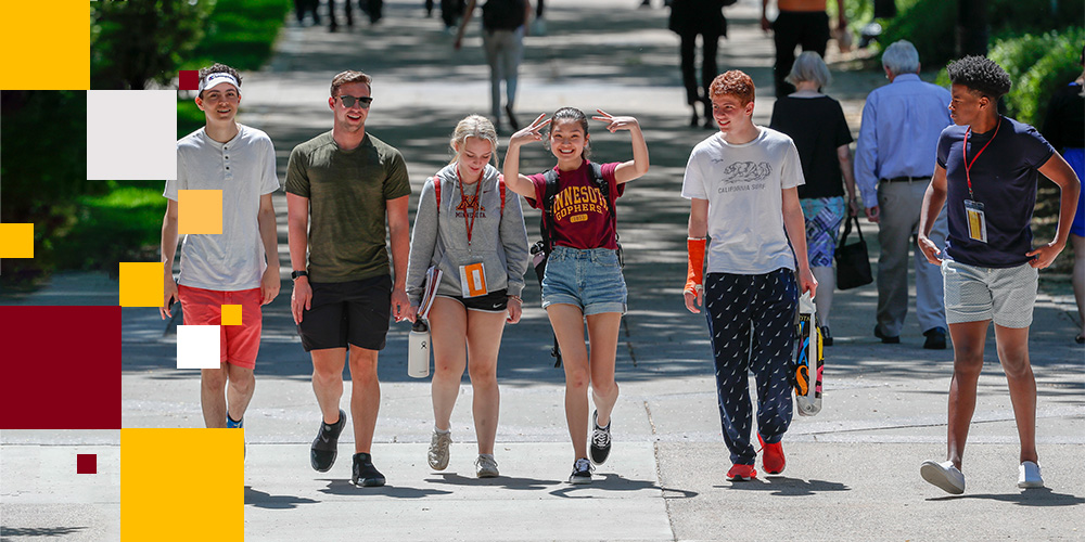 Group of six students walking on a sidewalk through campus