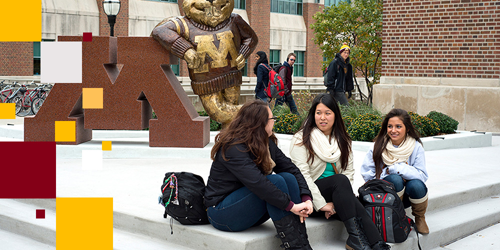 Students talking in front of the Goldy Statue
