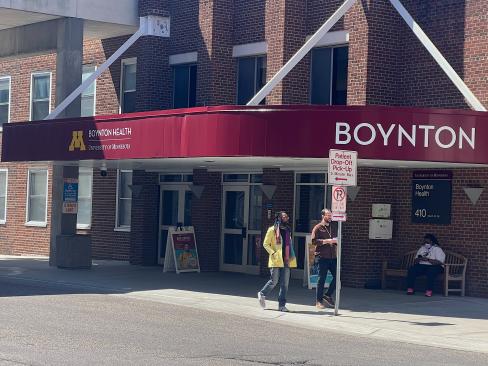 Two people walk outside Boynton Health