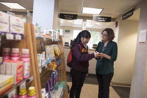 Pharmacist explains product to student